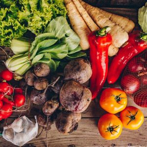 Panier de légumes biologiques : poivrons, panais, betteraves, tomates, choux, oignons, radis